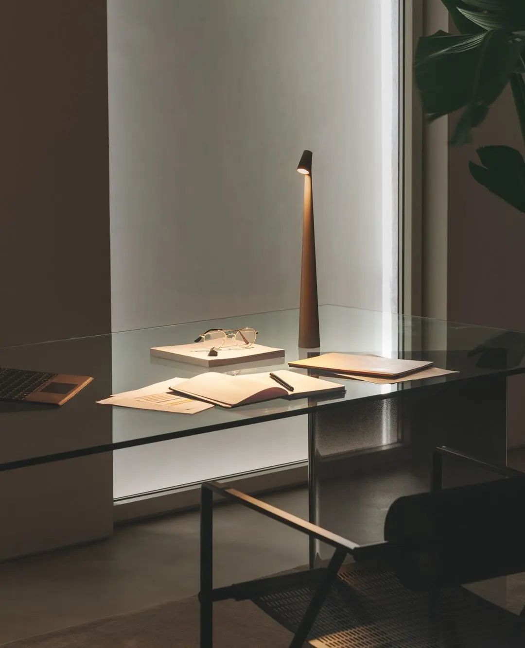 Modern AuraStem rechargeable LED lamp on office desk with lights on